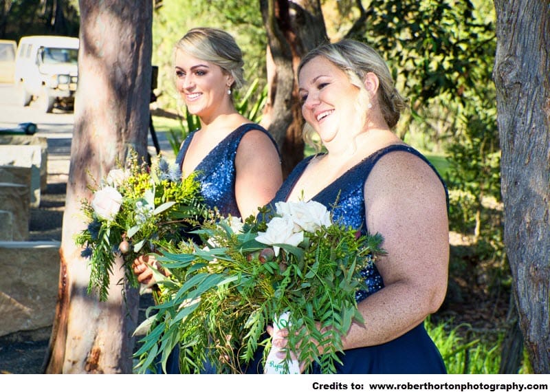 Two women holding a bouquet