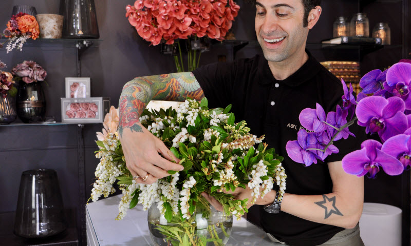 A florist arranging flowers in a vase