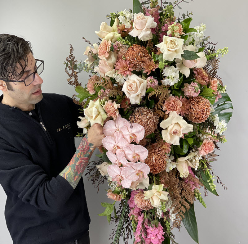 Florist fixing a funeral bouquet